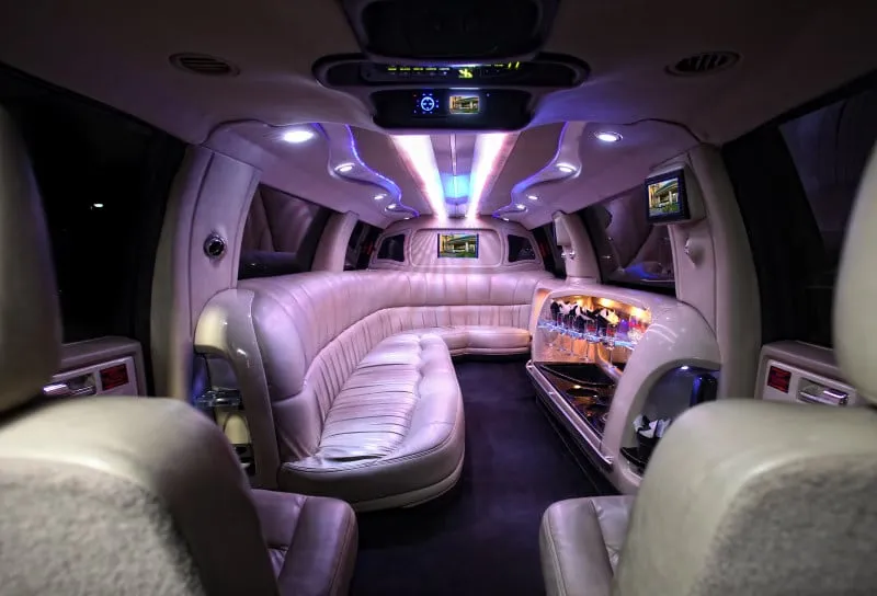 Escalade limousine interior with curved seating and bar