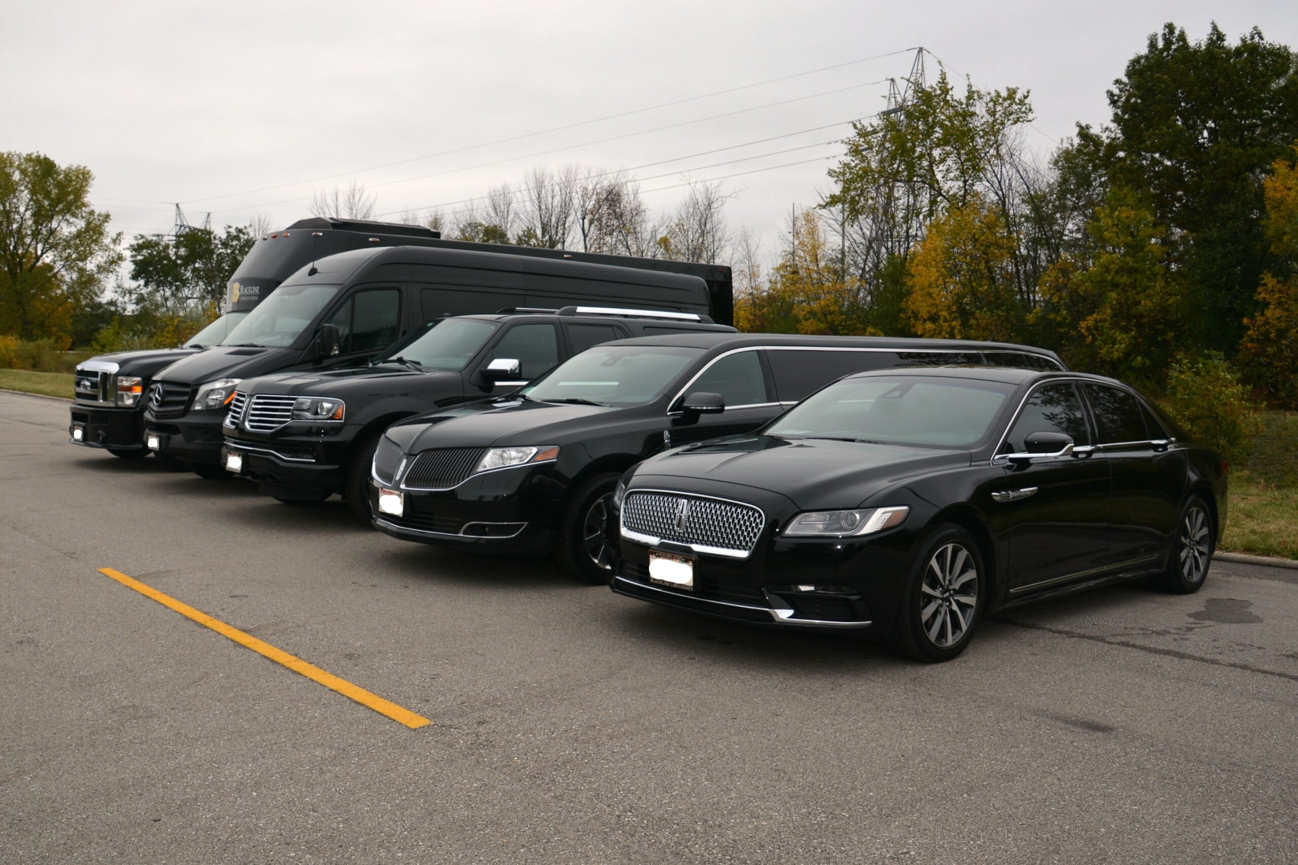 Fleet of premium black chauffeured limousines