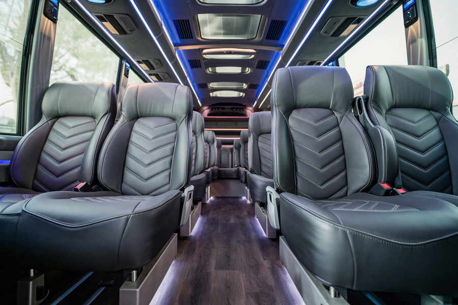 20 passenger shuttle bus interior with black leather seats and blue ambient lighting